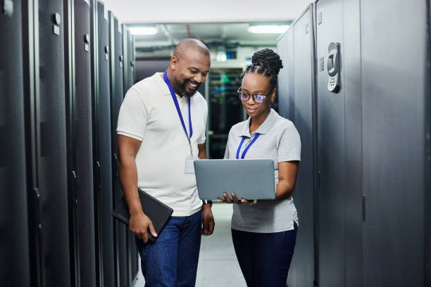 istock Shot of two technicians working together on a laptop in a server room 1334004253