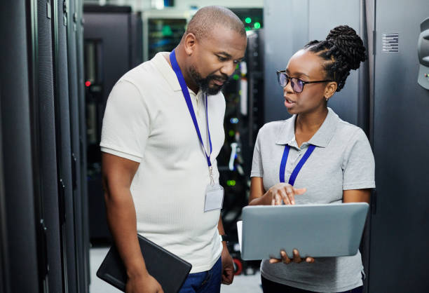 istock Shot of two technicians working together on a laptop in a server room 1334004262