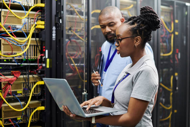 istock Shot of two technicians working together on a laptop in a server room 1334004285