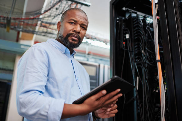 istock Portrait of a mature man using a digital tablet in a server room 1334005219