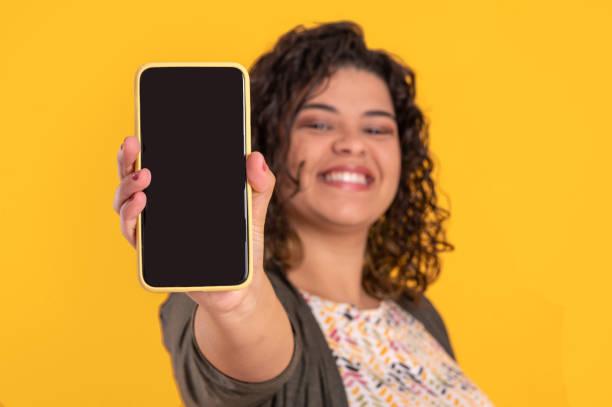 istock young woman with a cell phone on colorful background 1334005371