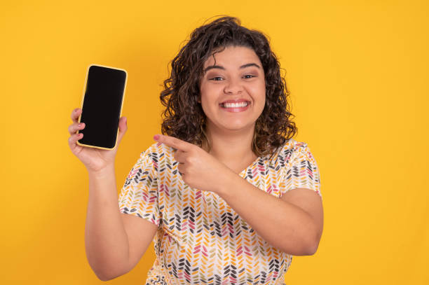 istock young woman with a cell phone on colorful background 1334005387