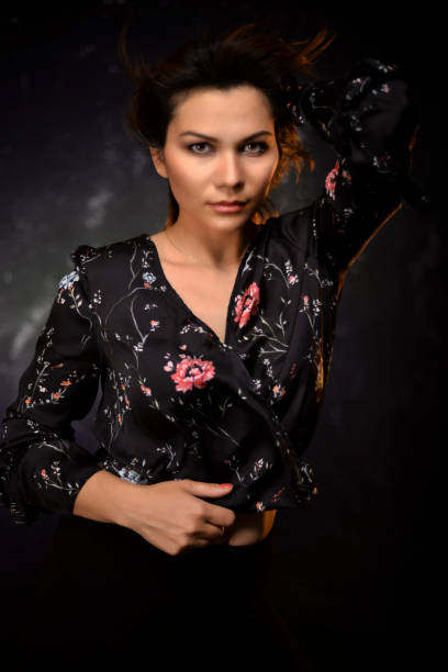istock Woman looking at camera against black and textured background. 1334006798