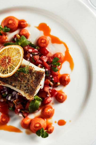 istock Black cod fillet on a vegetable stew, festive serving on a white grater on a table with white tablecloths 1334008504