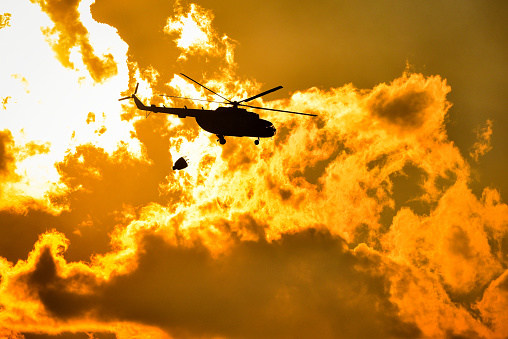Dramatic footage of a helicopter flying into a burning flames