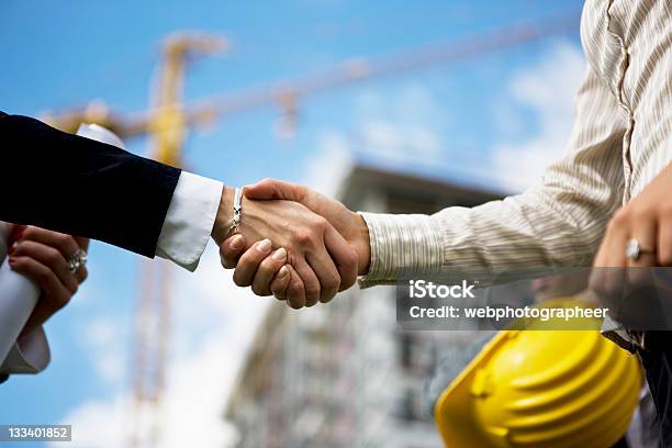 Selective Focus Of Handshake In Construction Yard Stock Photo - Download Image Now - Trust, Handshake, Construction Industry