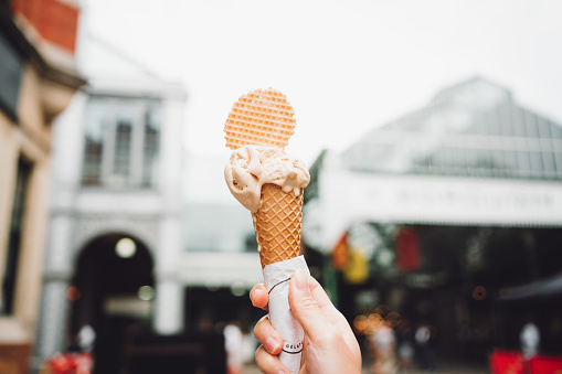 Woman hand holding ice cream at Borough market, London.