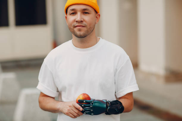 istock Young disabled man with artificial prosthetic hand in casual clothes. 1334022970