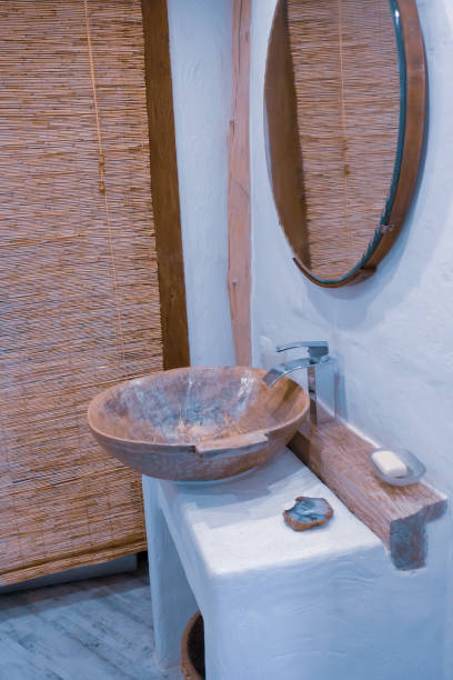 istock Loft style bathroom with washbasin and round mirror 1334023124