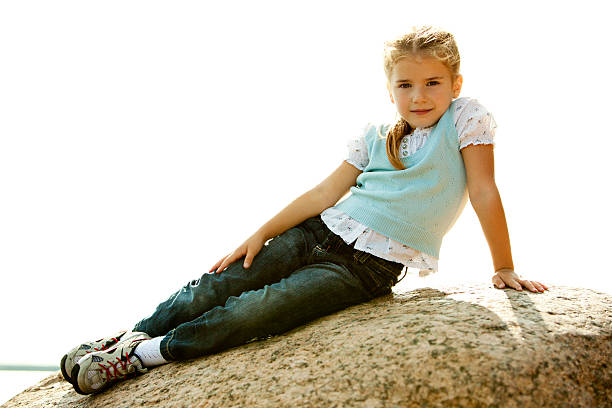 istock Little girl sitting on stone 133402953