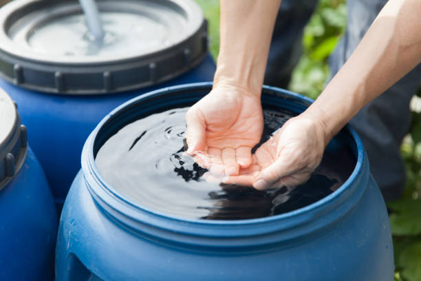 istock hands touching rainwater in tank 1334032741
