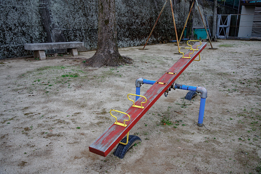 Sand park with a seesaw and swing for kids