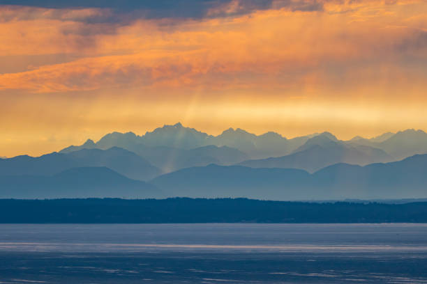 Sun Dogs Dapple the Olympic Mountains as Seen From Edmonds Sun Dogs Dapple the Olympic Mountains as Seen From Edmonds puget sound stock pictures, royalty-free photos & images