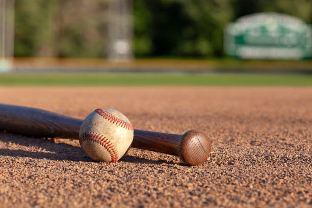 istock Baseball and bat low angle selective focus view on a baseball field 1334035288