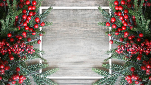 istock Christmas Holiday Evergreen Branches and Red Berries with White Empty Square Frame Template Over Wood Background with Copy Space 1334035955