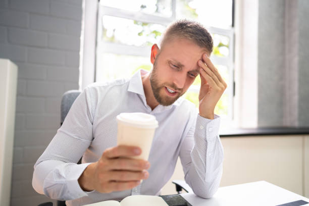 istock Person Holding Coffee Cup Having Headache 1334046779