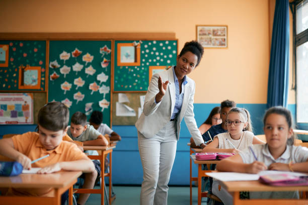 istock African American teacher teaching students in a classroom at elementary school. 1334050894