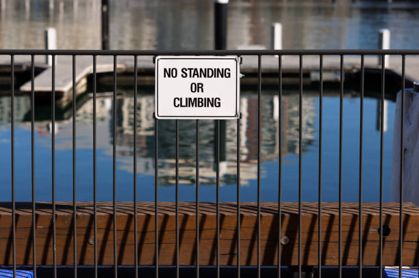 istock No standing or climbing sign on a marina fence 1334051999