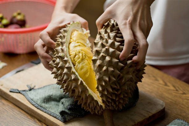 istock Midsection Of Woman Peeling Durian On Table 1334060402