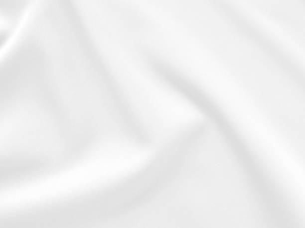 istock White grey fabric luxurious with a soft wave, abstract blurred background. 1334060557