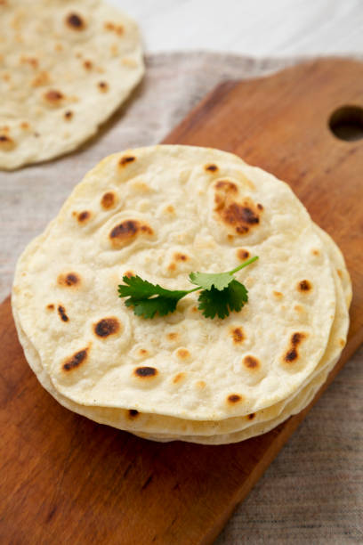 istock Homemade Roti Chapati Flatbread on a rustic wooden board, low angle view. Close-up. 1334060738