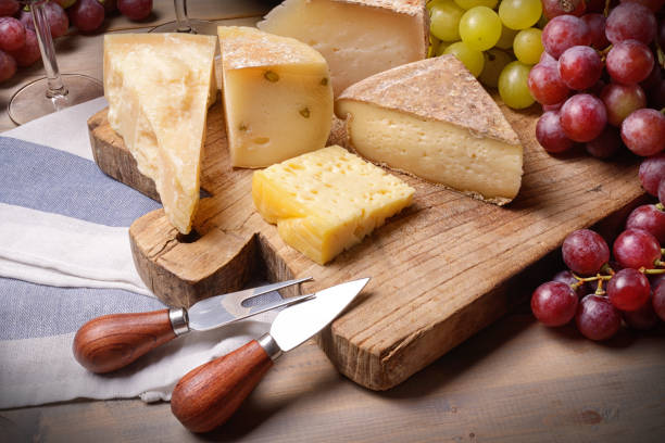 istock Cheese board with grapes on wooden table, close-up. 1334060799