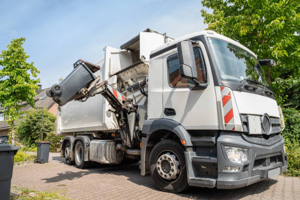istock automated garbage collection - hydraulic side loader of a white garbage truck grabs the garbage can to empty it 1334061591