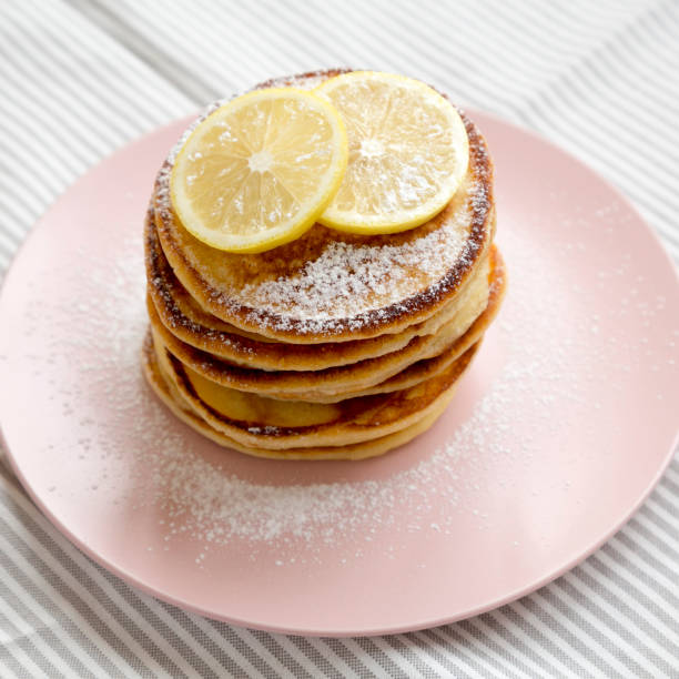 istock Homemade Lemon Ricotta Pancakes on a pink plate, low angle view. Close-up. 1334061663