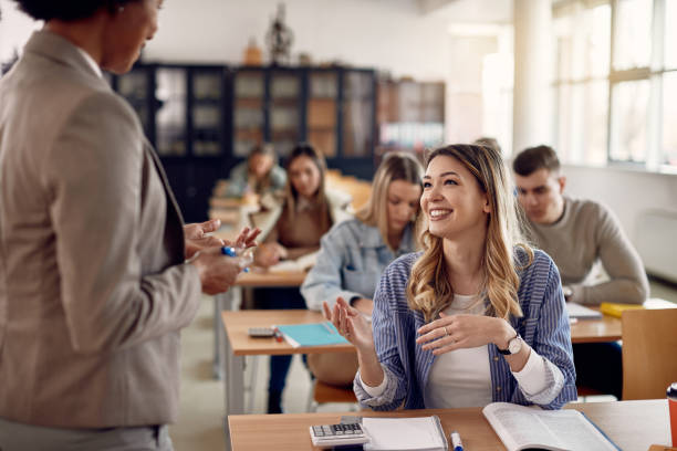 istock Young happy student talking to her teacher during a class in the classroom. 1334063674