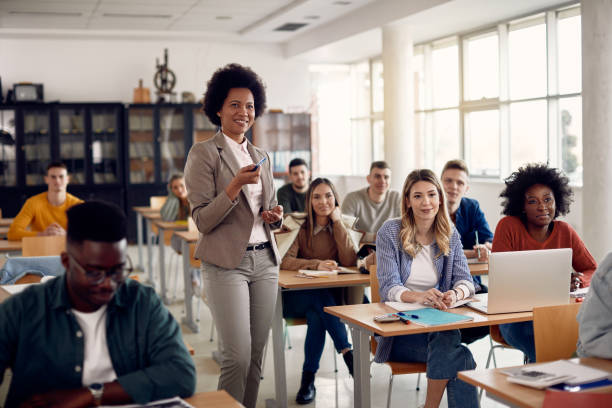 istock Happy black professor teaching group of college students in the classroom. 1334063684