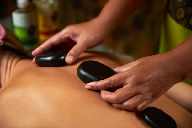 istock The master does back massage with special stones, spa treatments, magnets 1334063811