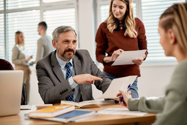 istock Mature professor having consultations with students at the university. 1334065558