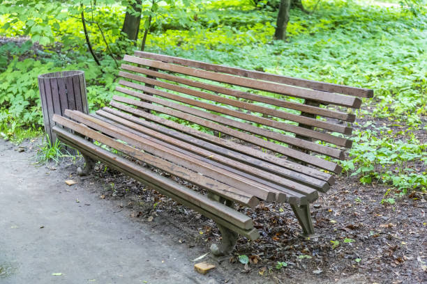 istock Comfortable wooden bench in the city park 1334067094