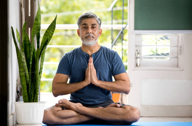 istock Man meditating on exercise mat at home 1334071292