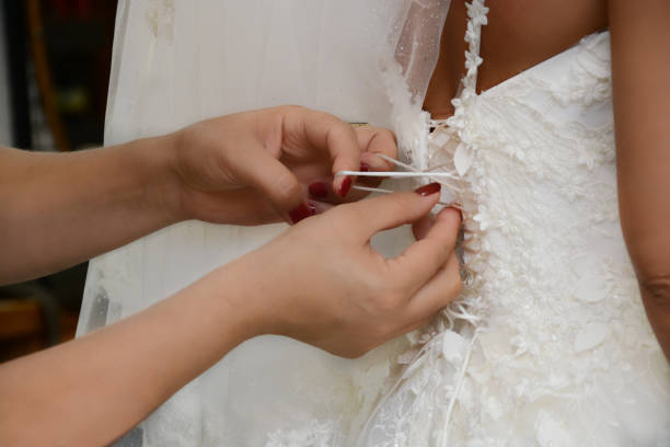 istock hand helping bride dress 1334072046