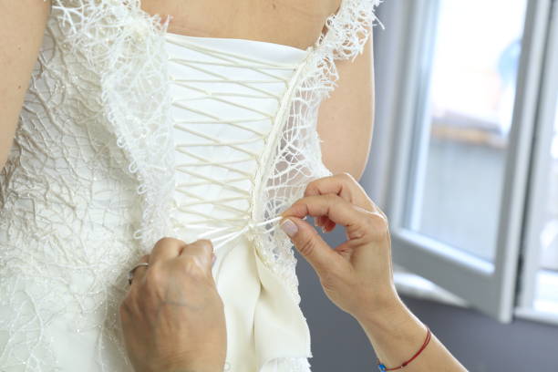 istock hand helping bride dress 1334072062