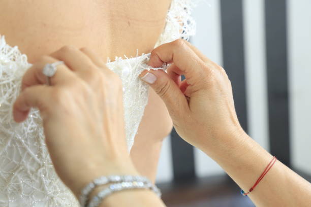 istock hand helping bride dress 1334072088