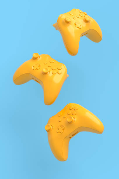 istock Flying gamer joysticks or gamepads on blue and yellow background 1334072123