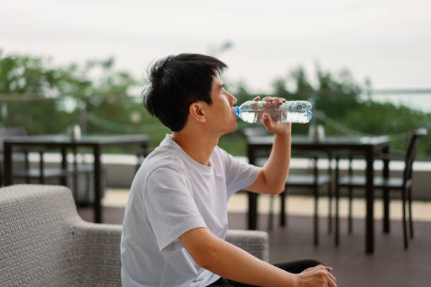 istock An Asian man is drinking mineral water 1334072963