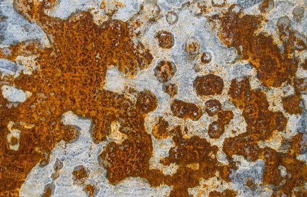 Rusty pattern patches white zinc red rust stains damage rotting. stock photo