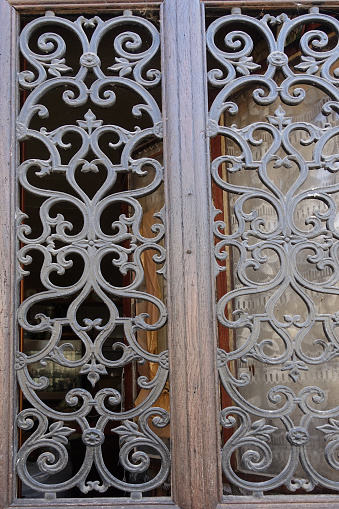 Old-fashioned entrance door with artisanal ironwork