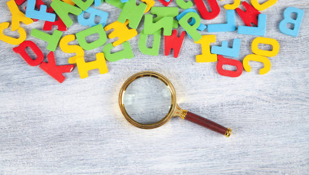 istock Magnifying glass with a colorful letters. 1334078939
