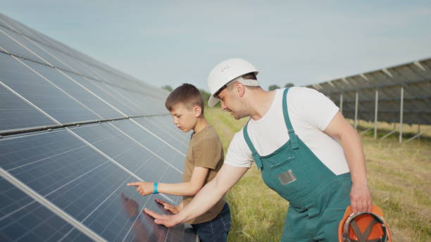 istock An young engineer father is explaining to his little son an operation and performance of photovoltaic solar panels at sunset. Concept: renewable energy, technology, electricity, green, future, family 1334080869