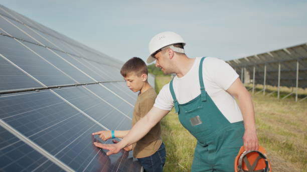 istock An young engineer father is explaining to his little son an operation and performance of photovoltaic solar panels at sunset. Concept: renewable energy, technology, electricity, green, future, family 1334080873