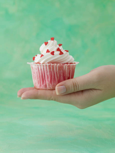 istock Woman Holding Cupcake 1334083770