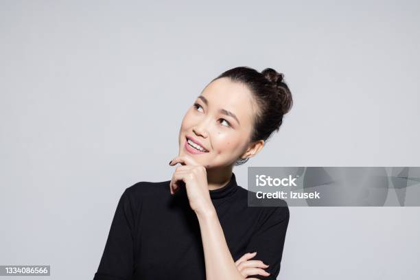 Thoughtful Asian Young Woman Stock Photo - Download Image Now - Smiling, Contemplation, Females