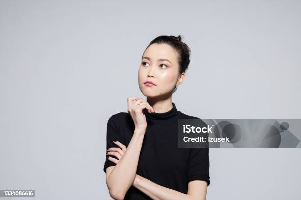 Thoughtful Asian Young Woman Stock Photo - Download Image Now - Contemplation, Asian and Indian Ethnicities, Worried