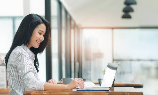 istock Young beautiful asian woman working on computer at home. 1334087735