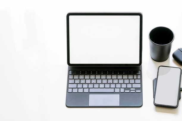 istock Mockup blank screen tablet and smartphone on white table, black and white color design. 1334087787
