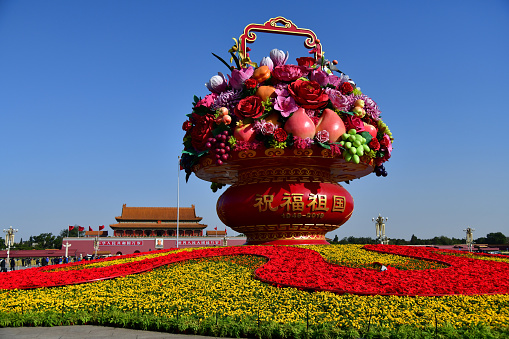 Beijing, China-October 2019; Forbidden city and giant flower pot. Chinese text: Long Live the People's Republic of China and Long live unity of the people of the world. On pot: Blessing the Motherland